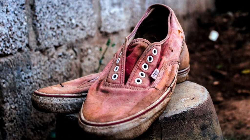 A pair of very old and worn-out shoes.