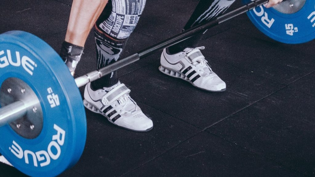 A person geared up with specialized weightlifting shoes for enhanced performance.
